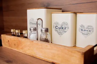 a wooden shelf with bottles of essential oils on it at Charming studio near Prague Airport in Tuchoměřice