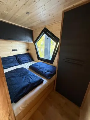 a small room with two beds in a tiny house at House Boat s výhledem na Wake Port in Brandýs nad Labem-Stará Boleslav