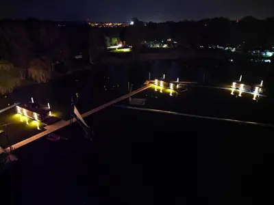 an aerial view of a dock at night with lights at House Boat s výhledem na Wake Port in Brandýs nad Labem-Stará Boleslav