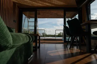 a living room with a couch and a window at House Boat s výhledem na Wake Port in Brandýs nad Labem-Stará Boleslav