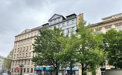 a large white building with trees in front of it at Sights at Your Doorstep in Prague