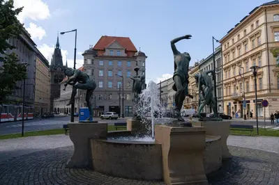 a fountain in the middle of a city with statues at Sights at Your Doorstep in Prague