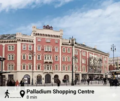 a large pink building with people walking in front of it at Sights at Your Doorstep in Prague