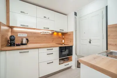 a kitchen with white cabinets and a microwave at Sights at Your Doorstep in Prague
