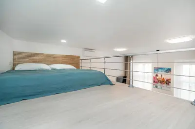 a bedroom with a large bed with blue sheets at Sights at Your Doorstep in Prague