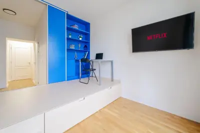 a living room with a blue and white wall at Chic Brick Suites in Historic Prague City Center by Rentez in Prague