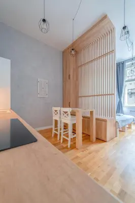 a living room with a table and a bed at Chic Brick Suites in Historic Prague City Center by Rentez in Prague