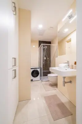 a bathroom with a sink and a toilet and a shower at Chic Brick Suites in Historic Prague City Center by Rentez in Prague
