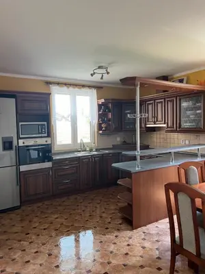 a kitchen with wooden cabinets and a counter top at Ubytování v Nalžovicích in Nalžovice