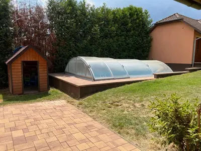 a greenhouse and a dog house in a yard at Ubytování v Nalžovicích in Nalžovice