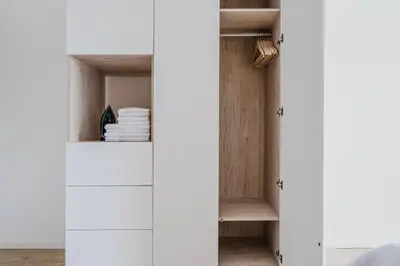 a wardrobe with white cabinets in a room at Blueground Vinohrady close to Namesti Miru PRG-2 in Prague