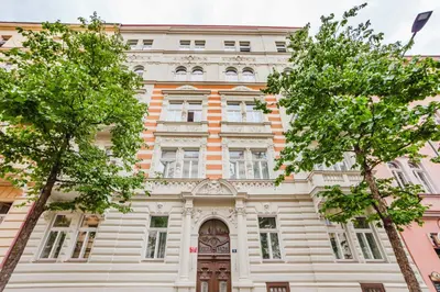 an old building with trees in front of it at Blueground Vinohrady close to Namesti Miru PRG-2 in Prague