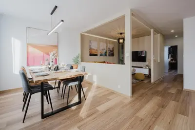a dining room and living room with a table and chairs at Prague Days - Two-Bedroom Apartment with Workspace and 200Mbps WiFi in Prague