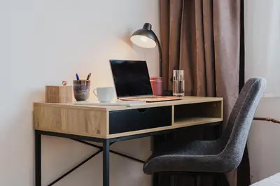 a desk with a laptop and a chair at Prague Days - Two-Bedroom Apartment with Workspace and 200Mbps WiFi in Prague
