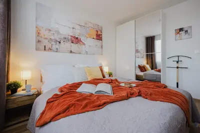 a bedroom with a bed with two books on it at Prague Days - Two-Bedroom Apartment with Workspace and 200Mbps WiFi in Prague