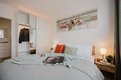 a bedroom with a bed with a book on it at Prague Days - Two-Bedroom Apartment with Workspace and 200Mbps WiFi in Prague