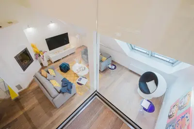 an overhead view of a living room with a couch and a tv at Prague Days - Three-bedroom Loft with Fireplace in Pop-art Style in Prague