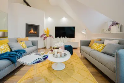 a living room with two couches and a table at Prague Days - Three-bedroom Loft with Fireplace in Pop-art Style in Prague