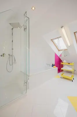 a white bathroom with a glass shower stall at Prague Days - Three-bedroom Loft with Fireplace in Pop-art Style in Prague