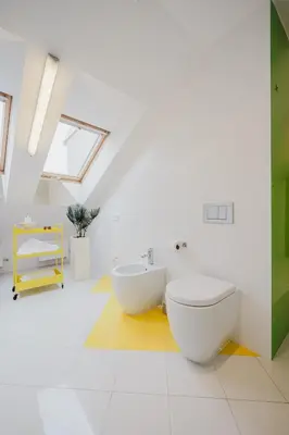 a white bathroom with a toilet and a sink at Prague Days - Three-bedroom Loft with Fireplace in Pop-art Style in Prague
