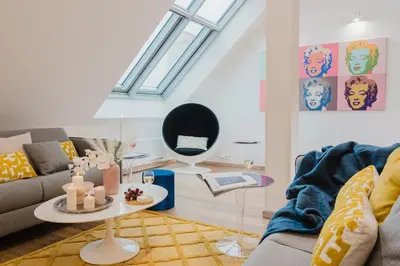 a living room with a couch and a table at Prague Days - Three-bedroom Loft with Fireplace in Pop-art Style in Prague