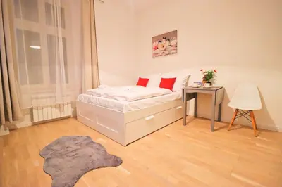 a bedroom with a bed and a table with a table at Spacious apartment in the center of Prague in Prague