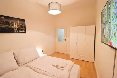 a room with a bed and a painting on the wall at Spacious apartment in the center of Prague in Prague