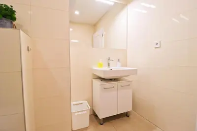 a white bathroom with a sink and a mirror at Spacious apartment in the center of Prague in Prague