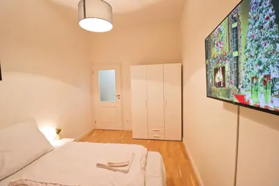 a room with a bed and a painting on the wall at Spacious apartment in the center of Prague in Prague