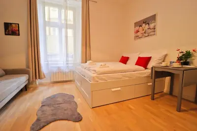 a small room with a bed and a table at Spacious apartment in the center of Prague in Prague