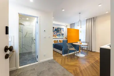 a living room with a bed and a table in a room at Design Apartments close to Wenceslas Square with AC in Prague