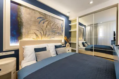 a bedroom with a bed and a painting on the wall at Design Apartments close to Wenceslas Square with AC in Prague