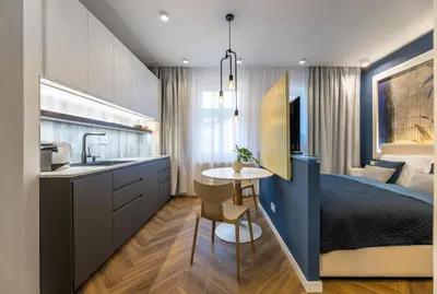 a kitchen and a bedroom with a bed and a table at Design Apartments close to Wenceslas Square with AC in Prague