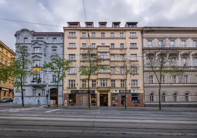 a large building on a city street with a street at Design Apartments close to Wenceslas Square with AC in Prague