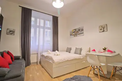 a bedroom with a bed and a desk in it at Modern apartment in the heart of Prague in Prague