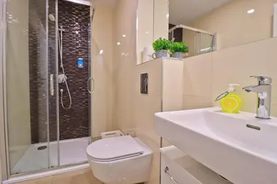 a bathroom with a toilet and a sink and a shower at Modern apartment in the heart of Prague in Prague