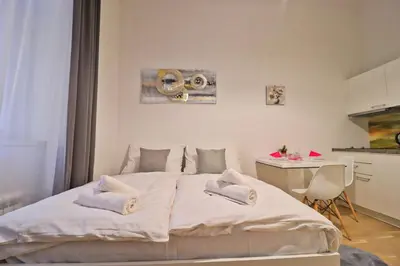 a bedroom with a white bed with two pillows on it at Modern apartment in the heart of Prague in Prague