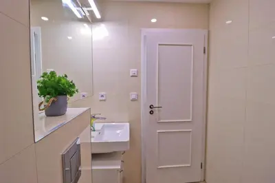 a white bathroom with a sink and a mirror at Modern apartment in the heart of Prague in Prague