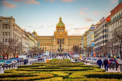 a large building with a clock tower in a city at Modern apartment in the heart of Prague in Prague