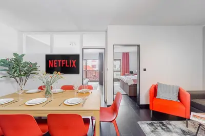 a dining room with a table and red chairs at Deluxe apartments near center Prague in Prague