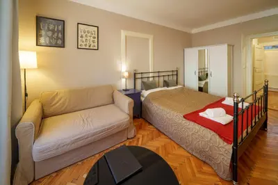 a living room with a couch and a bed at 3 Bed Flat - Sleeps 12 - Wifi in Prague
