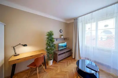 a room with a desk and a tv and a window at 3 Bed Flat - Sleeps 12 - Wifi in Prague