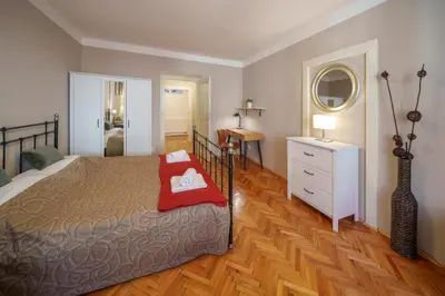a bedroom with a bed and a dresser and a mirror at 3 Bed Flat - Sleeps 12 - Wifi in Prague