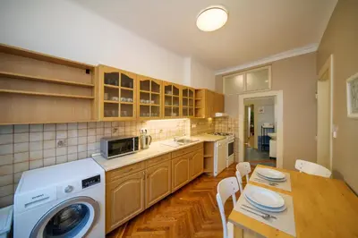 a kitchen with a table and a washing machine in it at 3 Bed Flat - Sleeps 12 - Wifi in Prague