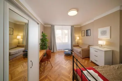 a living room with a bed and a couch at 3 Bed Flat - Sleeps 12 - Wifi in Prague