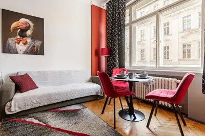 a living room with a couch and a table at Place of Grace - 1 min to National Theatre in Prague