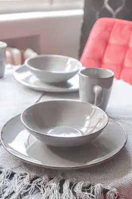 a table with three plates and cups on it at Place of Grace - 1 min to National Theatre in Prague