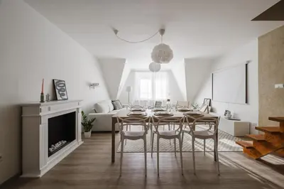 a dining room with a table and chairs and a fireplace at Spacious 4-Story Home with Sauna & Garden in Prague