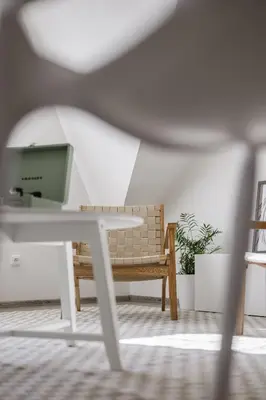 a living room with a bench and a table at Spacious 4-Story Home with Sauna & Garden in Prague