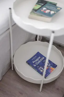 a book sitting on a stool next to a table at Spacious 4-Story Home with Sauna & Garden in Prague